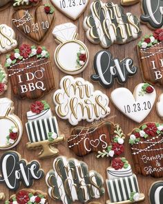 decorated cookies are arranged on a table with the names and date to be printed on them