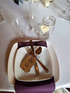 a white plate topped with forks and knives