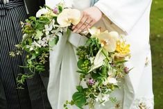 the bride and groom are holding their bouquets