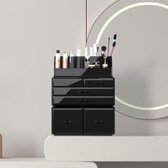 an assortment of makeup brushes on top of a dresser in front of a circular mirror