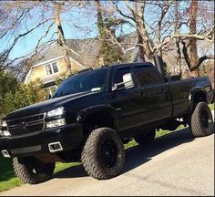 a black truck parked on the side of a road