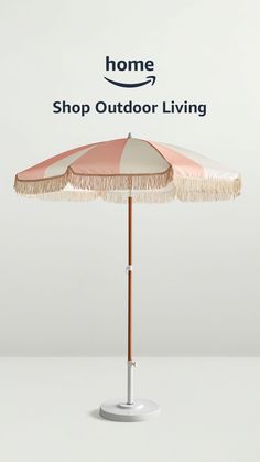 an umbrella with fringes on it sitting in front of a white background and the words home shop outdoor living