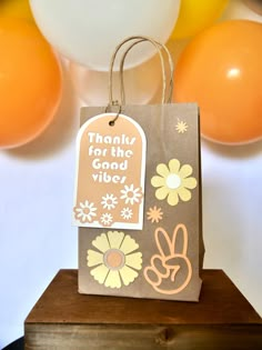 a brown paper bag with an orange and white balloon in the background