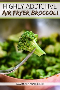 the broccoli is being held up by a fork with text overlay that reads, highly addictive air fryer broccoli