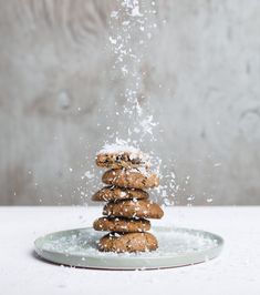 a stack of cookies is sprinkled with powder