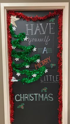 a chalk board with christmas decorations on it