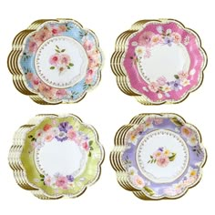 four plates with floral designs on them