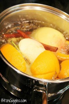 oranges and other fruits are cooking in a pot