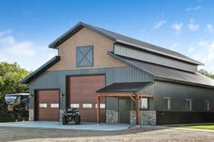 a barn with a tractor parked in front of it