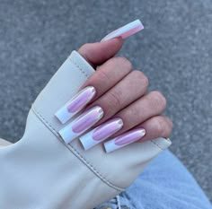 a woman's hand with pink and white acrylic nails