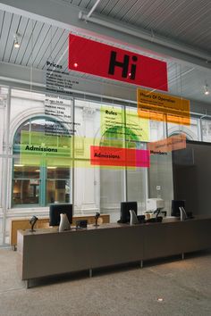 the inside of an office building with signs hanging from the ceiling