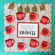 a cup of kindness card with coffee mugs on it and some paper hearts hanging from clothes pins