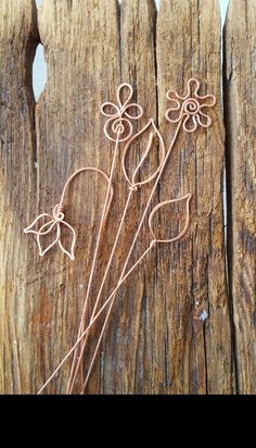 wire work on wood with flowers in the center