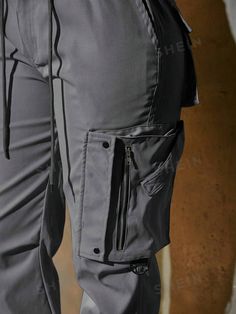 Details:Button \nStyle:Casual \nClosure Type:Elastic Waist \nDetails:Pocket \nDetails:Zipper \nColor:Dark Grey \nPattern Type:Plain \nType:Jogger \nWaist Line:Natural \nLength:Long \nFit Type:Loose \nFabric:Slight Stretch \nMaterial:Fabric \nComposition:100% Polyester \nCare Instructions:Hand wash,do not dry clean \nTemperature:Spring/Fall (18-25℃/63-77℉) \nBody:Unlined \nSheer:No \n Cargo Jogger Pants, Cargo Joggers, Type Of Pants, Casual Trousers, Zipper Detail, Jogger Pants, Fashion Online Shop, Trousers Women, Drawstring Waist