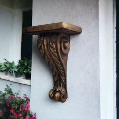 a wooden shelf on the side of a building