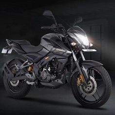 a black motorcycle parked in a dark room