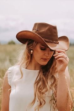 This womens leather cowboy hat is the perfect pairing of form and function. Built using durable, finished, 100% leather, it's built to last and protect you from the sun and rain on any adventure. Yet with its curved brim, all-leather braided band, and beautiful finish, it's one of our best-looking hats. Choose from a bright, stylish copper leather, or all-black desperado look. This hat is perfect for you! Leather Cowboy Hats, American Hat Makers, Sun And Rain, Cowgirl Hat, Leather Hats, Quality Hats, Cowgirl Hats, Hat Band, Cowboy Hat