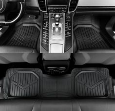 the interior of a car with black floor mats