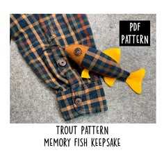 an image of a fish toy on the floor with text overlay that reads, trout pattern memory fish keepsake