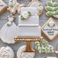 decorated wedding cookies are displayed on a table