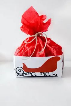 a red and white gift bag with the word caper on it