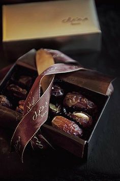 a box filled with assorted chocolates on top of a table