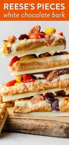 reese's pieces white chocolate bark is stacked on top of each other with the words reese's pieces written above it