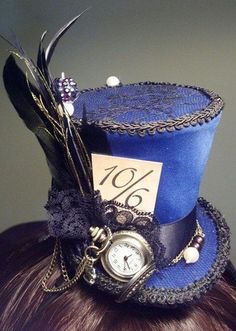 a woman wearing a blue top hat with a clock on it's side and a price tag