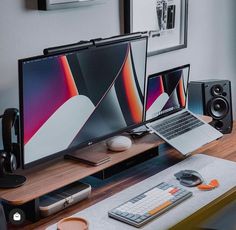 a laptop computer sitting on top of a wooden desk