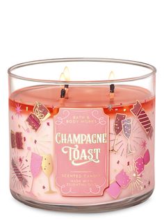 a pink candle that is inside of a glass container with some lights on top of it