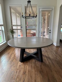 a dining room table in the middle of a wood floor