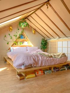 an attic bedroom with a bed and bookshelf