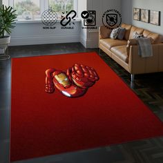 a living room with a red carpet that has a cartoon crab on it and two chairs in the background