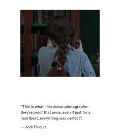 an image of a woman with her hair in a fishtail braid looking at bookshelves