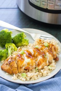 chicken and rice with broccoli on a plate next to an instant pressure cooker