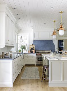 an instagram photo of a kitchen with white cabinets and wood flooring on the walls