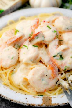 a plate with shrimp and pasta on it