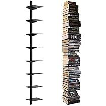 a tall black book shelf next to a stack of books on top of each other