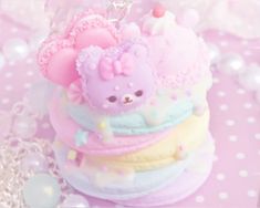 there is a small toy bear on top of some cakes