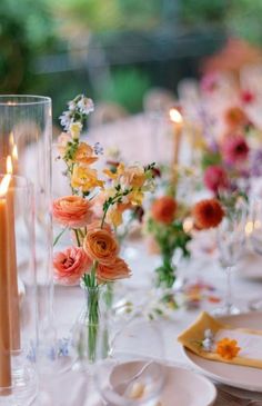 an image of a table setting with flowers and candles