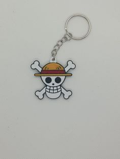 a skull and crossbones keychain with a hat on it's head