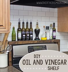 an old and vinegar shelf in the kitchen with bottles on it, next to a microwave