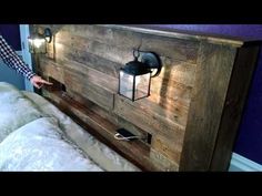 a bed with a wooden headboard made out of wood and some lights on it