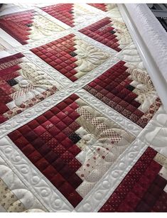 a red and white quilt is laying on the floor