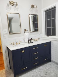 navy blue vanity, brass hardware, pottery barn, aesop, marble floors, farrow & ball, ammonite. Bathroom Tile Navy Vanity, Navy Bath, Small Bathroom With Navy Blue Vanity, Navy Grey And Gold Bathroom, Navy Blue Vanity Bathroom Ideas Tile, Small Vanity Backsplash, Midnight Blue Vanity Bathroom Ideas, Midnight Blue Bathroom Vanity, Dark Navy Bathroom Vanity