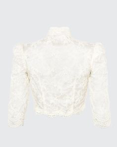 Our Bolero is a cropped scoop top with a mandarine neckline featuring three-quarter, high fitted sleeves. The Bolero is made with embroidered mesh lace and trimmed with an Alençon lace scallop trim. Embroidered mesh lace trimmed with Point d'Alençon Three-quarter sleeves Hook-and-eye closures center front Hand wash and flat dry or dry clean Each piece is made to order and handcrafted in our atelier. Elegant Cropped Lace Top, Long Sleeve Crop Top With Lace Trim For Party, Fitted Cropped Lace Top With Scalloped Edges, Formal Long Sleeve Tops With Scalloped Lace, Elegant Scalloped Lace Cropped Top, Fitted Cropped Lace Top With Scalloped Lace, Long Sleeve Lace Trim Crop Top For Party, Formal Fitted Blouse With Scalloped Lace, Elegant Long Sleeve Lace Crop Top