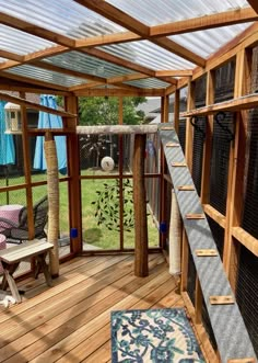 the inside of a house with wooden floors and glass walls on it's sides