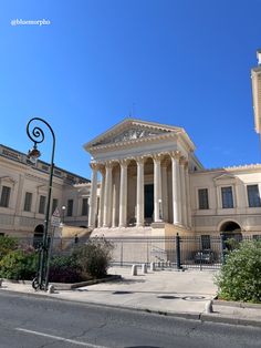 an old building with columns and pillars on the front