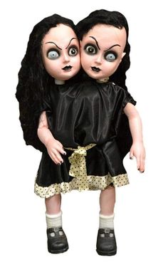 two creepy dolls are hugging each other with their eyes open and one is wearing a black dress