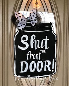 a door hanger that says shut from the door with polka dots and a bow